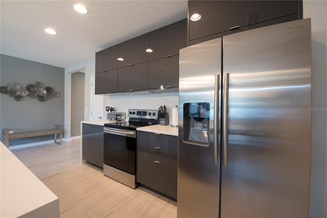 kitchen featuring gray cabinetry, light hardwood / wood-style floors, and stainless steel appliances