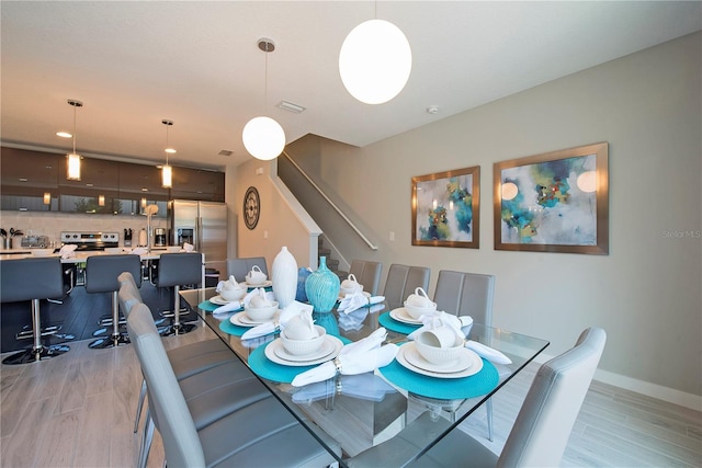 dining space featuring light wood-type flooring