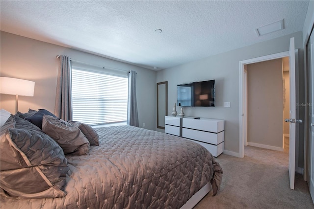 carpeted bedroom with a textured ceiling