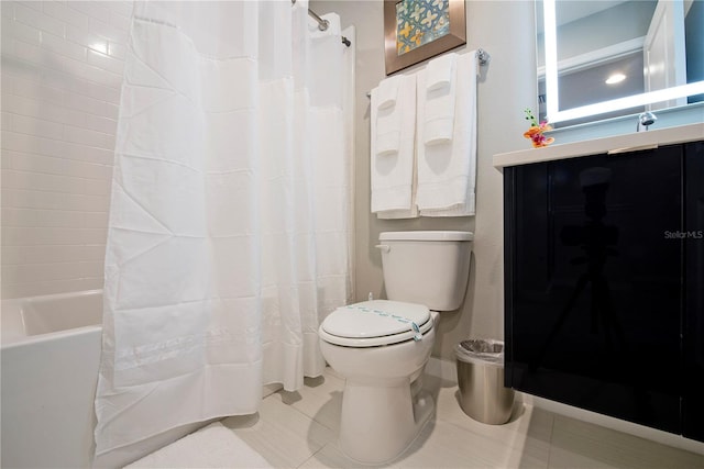 bathroom with toilet, tile floors, and shower / bath combo with shower curtain