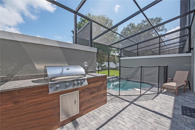 exterior space featuring glass enclosure, grilling area, pool water feature, and a patio area