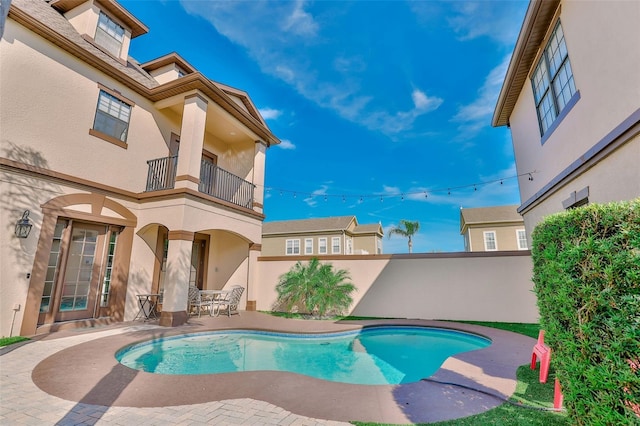 view of pool featuring fence, a fenced in pool, and a patio