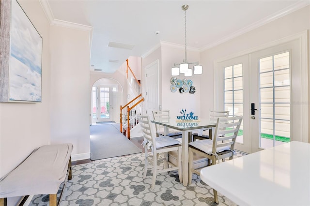 dining space featuring ornamental molding and french doors