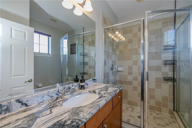 bathroom with an enclosed shower and vanity