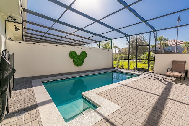 view of swimming pool featuring a patio and a lanai