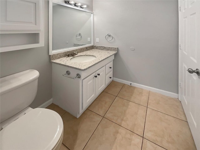 bathroom with vanity, tile patterned flooring, and toilet