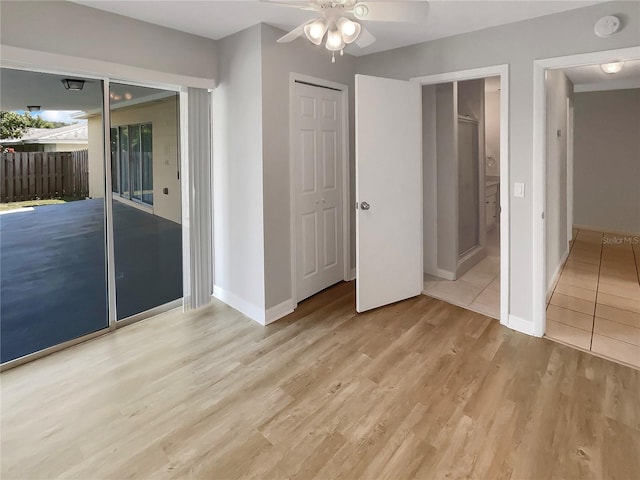 unfurnished bedroom with light wood-type flooring and ceiling fan