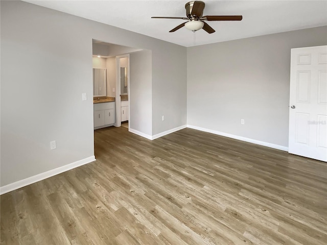 empty room featuring ceiling fan and hardwood / wood-style flooring