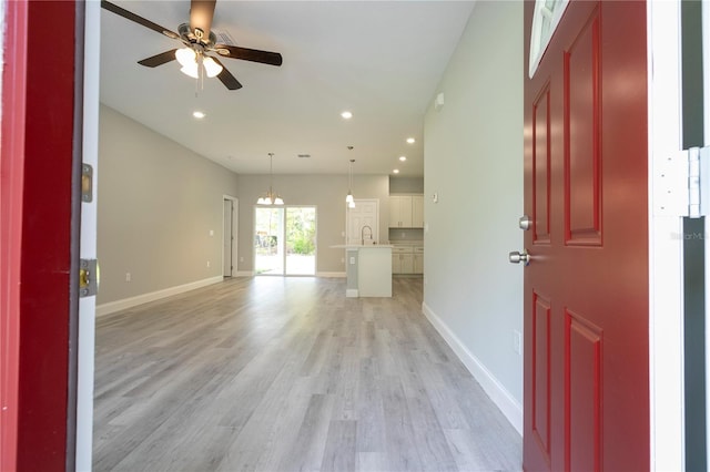 entrance foyer featuring ceiling fan, light hardwood / wood-style floors, and sink