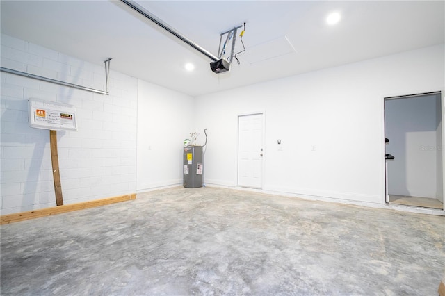 garage with a garage door opener and electric water heater