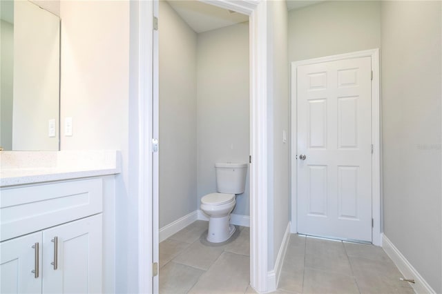 bathroom featuring toilet, tile patterned floors, and vanity