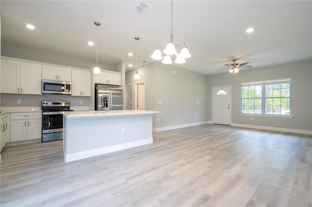 kitchen with white cabinetry, a center island, stainless steel appliances, and light hardwood / wood-style flooring