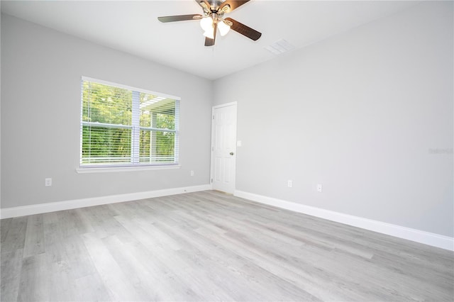 spare room featuring light hardwood / wood-style flooring and ceiling fan