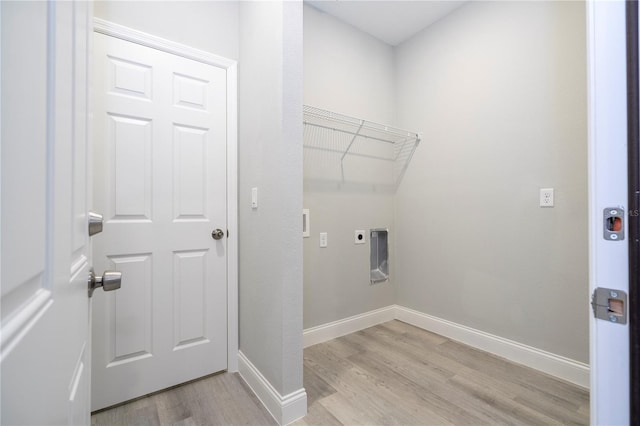 washroom featuring electric dryer hookup and light wood-type flooring