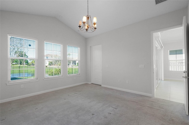 tiled spare room featuring an inviting chandelier and lofted ceiling