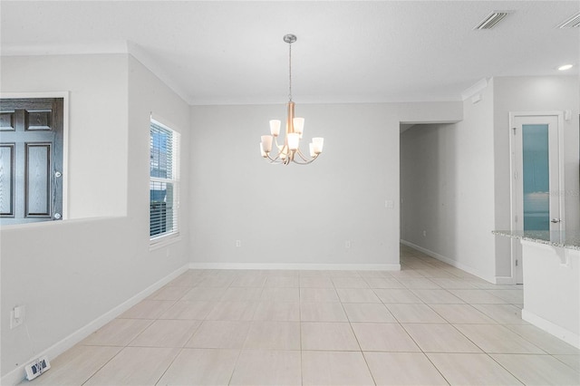 tiled spare room with a notable chandelier