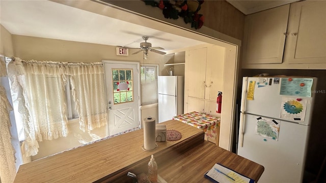 kitchen with white refrigerator, ceiling fan, and hardwood / wood-style flooring