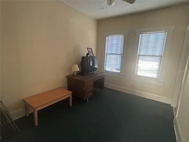 misc room featuring dark carpet and ceiling fan