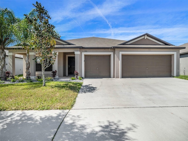 view of front of property with a front lawn and a garage