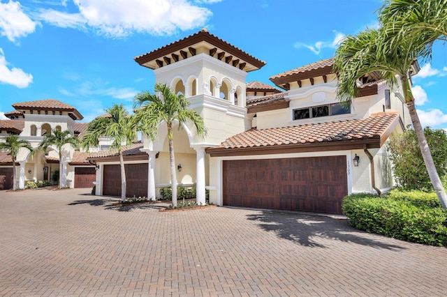 mediterranean / spanish home featuring a garage