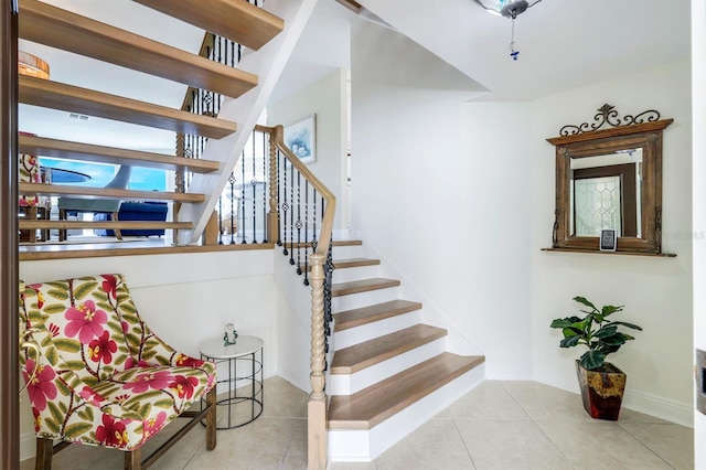 stairs featuring light tile flooring