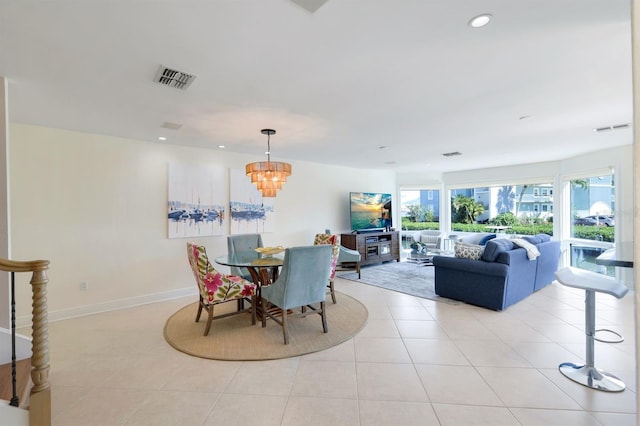 dining room with an inviting chandelier and light tile flooring