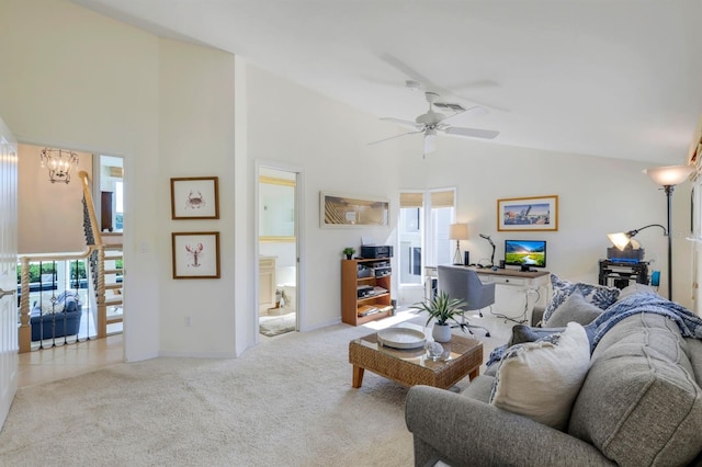 carpeted living room with vaulted ceiling and ceiling fan with notable chandelier