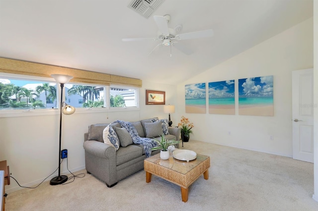 living room with ceiling fan, carpet floors, and lofted ceiling