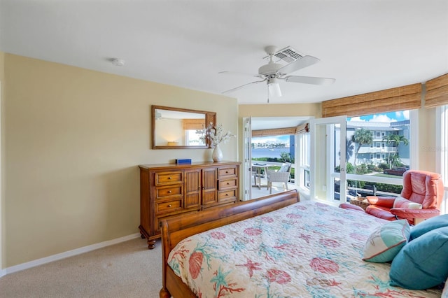 carpeted bedroom with ceiling fan, access to exterior, and multiple windows