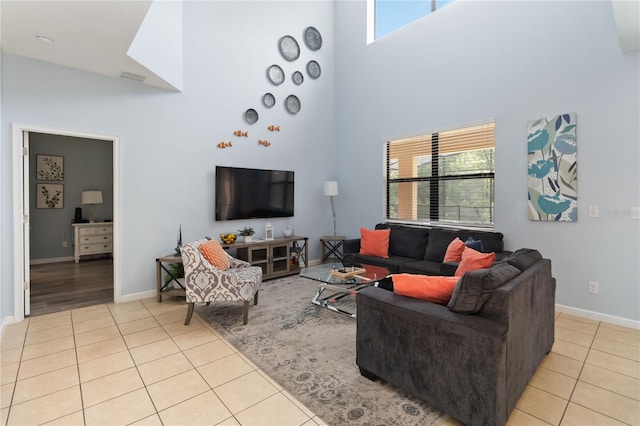 living room with light tile floors and a towering ceiling