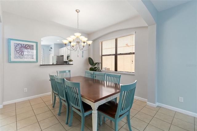 dining space with light tile flooring and a notable chandelier