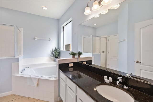 bathroom featuring double vanity, plus walk in shower, and tile flooring