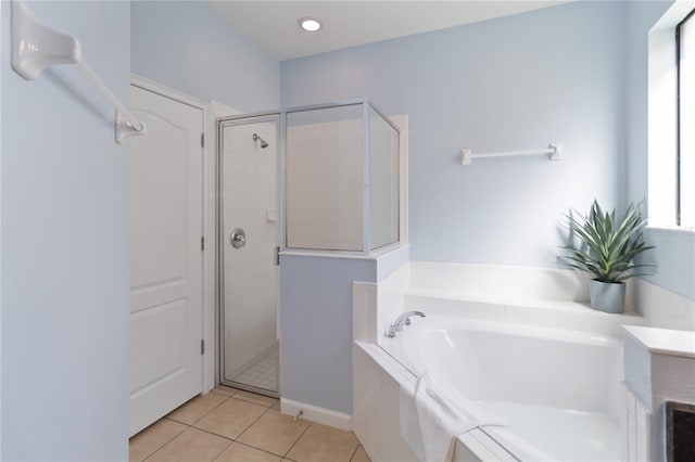 bathroom with plus walk in shower and tile flooring