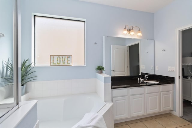 bathroom with a relaxing tiled bath, tile floors, and vanity