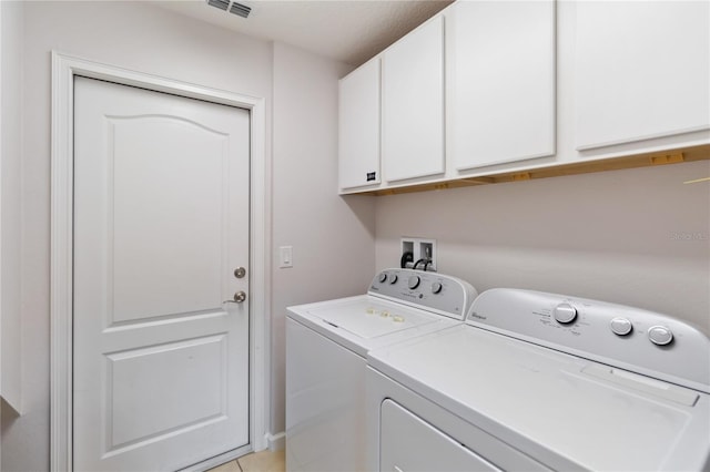 laundry area featuring washer hookup, light tile flooring, cabinets, and independent washer and dryer