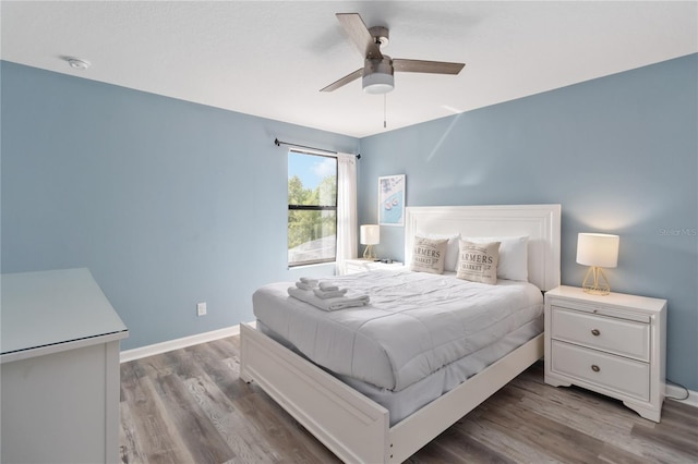 bedroom with wood-type flooring and ceiling fan