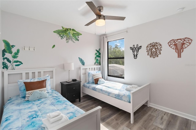 bedroom with ceiling fan and dark hardwood / wood-style flooring