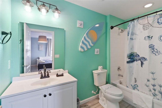 full bathroom with wood-type flooring, toilet, vanity, and shower / tub combo