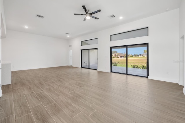 unfurnished living room with ceiling fan