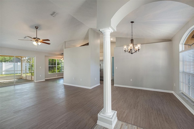 interior space featuring ceiling fan with notable chandelier, dark hardwood / wood-style flooring, ornate columns, and vaulted ceiling