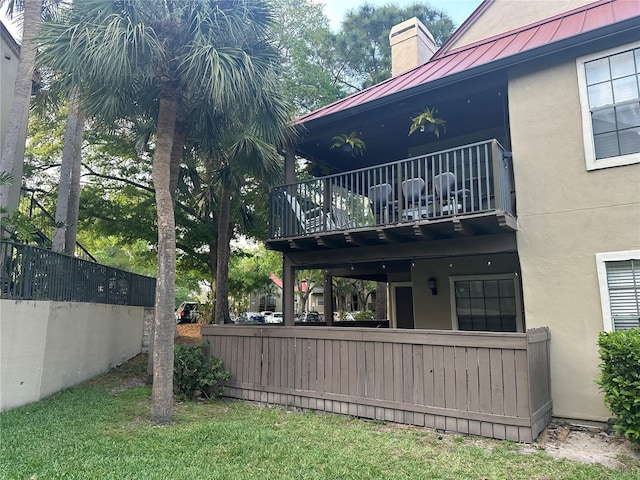 back of house featuring a balcony