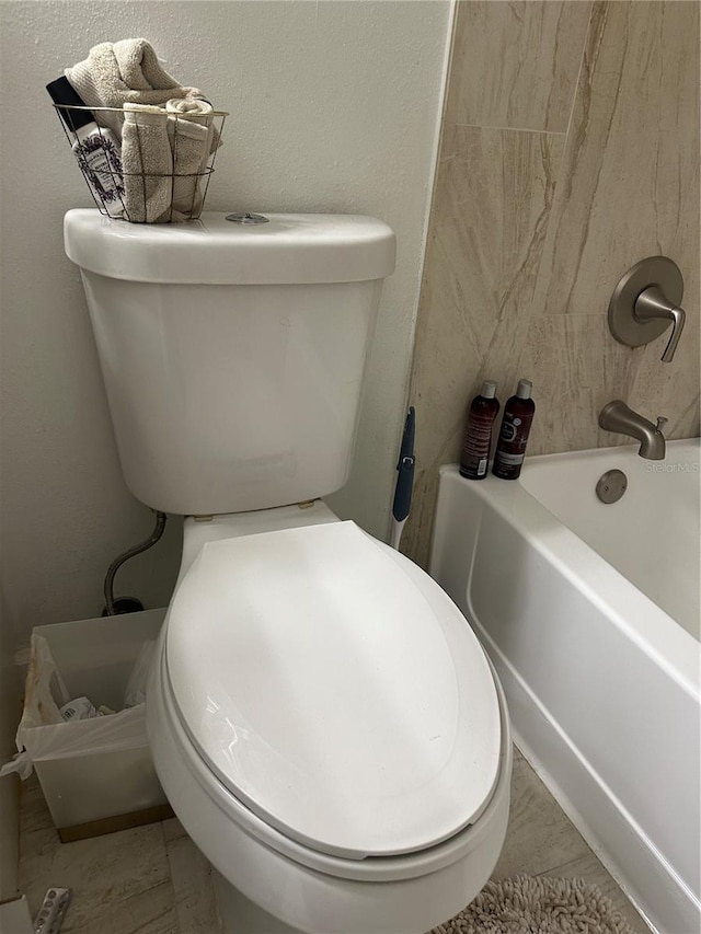 bathroom with tile flooring and toilet