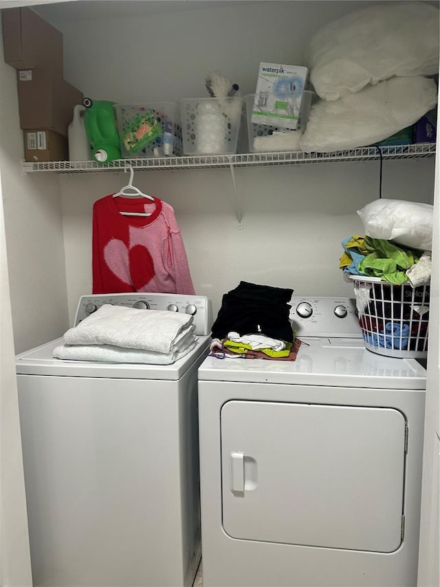 clothes washing area featuring washer and dryer