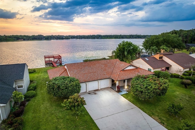 aerial view at dusk with a water view