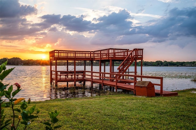 view of dock featuring a yard and a water view