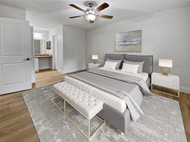 bedroom featuring ceiling fan, connected bathroom, and light hardwood / wood-style floors