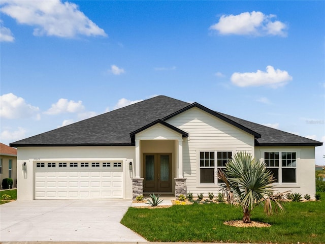 view of front of house featuring a front yard and a garage