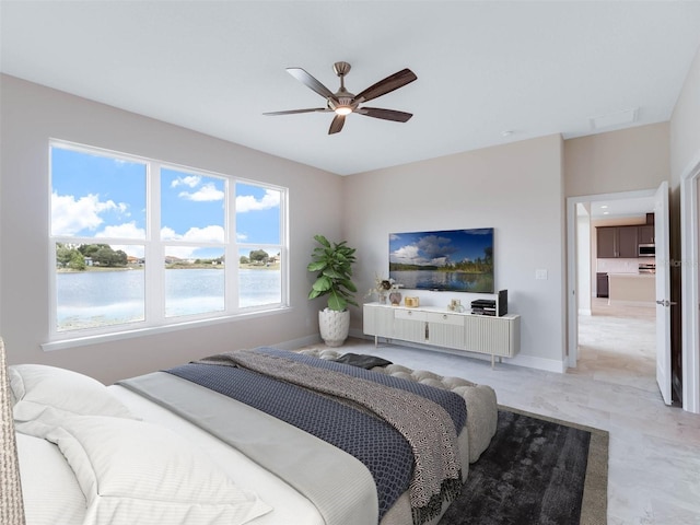 bedroom featuring ceiling fan, a water view, light tile floors, and multiple windows