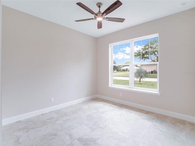 spare room featuring ceiling fan and light tile floors