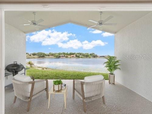 view of patio with ceiling fan and a water view